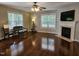 Bright living room featuring a fireplace, hardwood floors, and two large windows at 4116 Tall Pine Dr, Franklinton, NC 27525