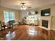 Bright living room features a fireplace, hardwood floors, and a large window at 4116 Tall Pine Dr, Franklinton, NC 27525
