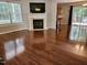 Bright living room with hardwood floors, a fireplace, and ample natural light creating a cozy atmosphere at 4116 Tall Pine Dr, Franklinton, NC 27525