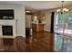 Open concept living room with fireplace, hardwood floors, and access to outdoor deck at 4116 Tall Pine Dr, Franklinton, NC 27525