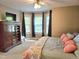 Comfortable bedroom featuring a large window, ceiling fan, and spacious closet at 4116 Tall Pine Dr, Franklinton, NC 27525