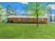Spacious backyard featuring well-kept lawn and brick exterior at 412 Winterlocken Dr, Sanford, NC 27330