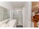 Bathroom features a white vanity, mirror, and shower with sliding glass doors at 412 Winterlocken Dr, Sanford, NC 27330