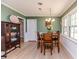 Bright dining area with wainscoting, stylish lighting, and a beautiful wooden dining table at 412 Winterlocken Dr, Sanford, NC 27330