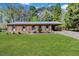 Charming single-story brick home with a well-maintained front yard and covered parking at 412 Winterlocken Dr, Sanford, NC 27330