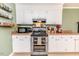 Kitchen featuring a double oven, white cabinets, and granite countertops at 412 Winterlocken Dr, Sanford, NC 27330