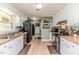 Functional kitchen with white cabinets, appliances, and a view to the laundry area at 412 Winterlocken Dr, Sanford, NC 27330