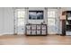 Living room featuring modern entertainment center and lots of natural light at 412 Winterlocken Dr, Sanford, NC 27330