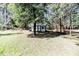 Backyard shed surrounded by mature trees, offering a peaceful setting at 412 Winterlocken Dr, Sanford, NC 27330