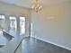 Dining area features chandelier, tiled floors, and backyard access at 4425 Moss Garden Path, Raleigh, NC 27616