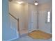 Welcoming foyer features hardwood floors, a staircase, and a coat closet for convenience at 4425 Moss Garden Path, Raleigh, NC 27616