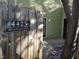 Welcoming front entrance with address plaque and rustic wooden gate to this charming home at 4425 Moss Garden Path, Raleigh, NC 27616
