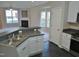 Open-concept kitchen with dark countertops, white cabinetry, and stainless-steel appliances at 4425 Moss Garden Path, Raleigh, NC 27616