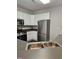 Bright kitchen featuring white cabinets, stainless steel appliances, and modern countertops at 4425 Moss Garden Path, Raleigh, NC 27616