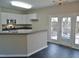 Kitchen features stainless steel appliances, breakfast bar, tiled floors and access to backyard at 4425 Moss Garden Path, Raleigh, NC 27616
