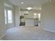 Open living area with a breakfast bar that connects to the kitchen and access to the outdoor patio at 4425 Moss Garden Path, Raleigh, NC 27616