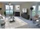 Staged living room featuring modern furnishings, a fireplace, and large windows providing lots of natural light at 4425 Moss Garden Path, Raleigh, NC 27616
