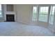 Bright living room featuring a fireplace and large windows letting in ample natural light at 4425 Moss Garden Path, Raleigh, NC 27616