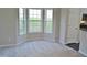 Bright living room features large windows, neutral color walls, and carpet at 4425 Moss Garden Path, Raleigh, NC 27616