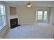 Large living room with neutral carpeting, fireplace, and many windows at 4425 Moss Garden Path, Raleigh, NC 27616