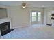 Open living room with fan, fireplace and bay window nook near kitchen at 4425 Moss Garden Path, Raleigh, NC 27616