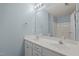 Well-lit bathroom featuring double sinks and a large mirror reflecting the shower and toilet area at 4447 Antique Ln, Raleigh, NC 27616