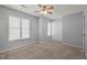 Neutral bedroom with plush carpet, natural light, and spacious closet at 4447 Antique Ln, Raleigh, NC 27616