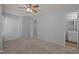 Bedroom with neutral walls, ceiling fan and view to ensuite bathroom at 4447 Antique Ln, Raleigh, NC 27616