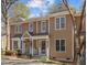 Charming townhome exterior featuring a covered front porch and neutral siding at 4447 Antique Ln, Raleigh, NC 27616