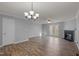 Spacious living room with hardwood floors, fireplace, ceiling fan, and glass doors to the outside at 4447 Antique Ln, Raleigh, NC 27616