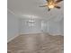 Open-concept living room with wood flooring and view into dining area at 4447 Antique Ln, Raleigh, NC 27616