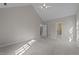 A carpeted bedroom with vaulted ceilings and open doorways at 5122 Berkeley St, Raleigh, NC 27612