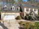 Traditional home with a two-car garage, manicured lawn and walkway leading to the front door at 5122 Berkeley St, Raleigh, NC 27612