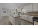 White kitchen with granite countertops, stainless steel appliances, and an island at 5122 Berkeley St, Raleigh, NC 27612