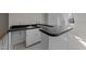 An upstairs kitchenette with a sink, counterspace, and white cabinets at 5122 Berkeley St, Raleigh, NC 27612