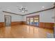 Large living room with hardwood floors and a view of the pool through the glass doors at 5122 Berkeley St, Raleigh, NC 27612