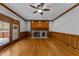 Spacious living room with hardwood floors, a wood-burning fireplace, and access to the deck at 5122 Berkeley St, Raleigh, NC 27612