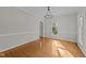 Sunlit living room featuring hardwood flooring, white trim, and a modern light fixture at 5122 Berkeley St, Raleigh, NC 27612