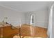 Sun-lit living room with hardwood floors, white molding, and a large window at 5122 Berkeley St, Raleigh, NC 27612