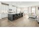 Spacious kitchen showcases an island with seating, stainless steel appliances, and an adjacent dining area at 557 Freedom Trail Dr, Willow Springs, NC 27592