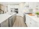 A well-equipped kitchen features stainless steel appliances, a spacious island, and quartz countertops at 557 Freedom Trail Dr, Willow Springs, NC 27592