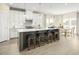 Bright kitchen boasts white cabinets, stainless steel appliances, a large island with seating, and stylish backsplash at 557 Freedom Trail Dr, Willow Springs, NC 27592