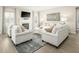 Bright living room with fireplace, gray patterned rug, and comfortable seating at 557 Freedom Trail Dr, Willow Springs, NC 27592