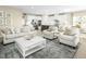 Open-concept living space features a kitchen with white cabinets and a cozy seating area at 557 Freedom Trail Dr, Willow Springs, NC 27592