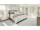 Comfortable main bedroom with neutral tones, soft carpet and lots of pillows at 557 Freedom Trail Dr, Willow Springs, NC 27592