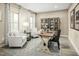 Cozy home office features a wooden desk, armchairs, and stylish cabinet at 557 Freedom Trail Dr, Willow Springs, NC 27592