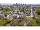 An aerial shot showcases the property's location and neighborhood in a tree-lined setting at 620 Wills Forest St, Raleigh, NC 27605