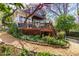 Inviting backyard features a wood deck, stairs and stone-lined landscape at 620 Wills Forest St, Raleigh, NC 27605