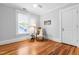 Bright bedroom with hardwood floors, a ceiling fan, and classic furnishings at 620 Wills Forest St, Raleigh, NC 27605