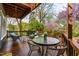 Spacious deck with outdoor seating and dining area surrounded by lush greenery at 620 Wills Forest St, Raleigh, NC 27605